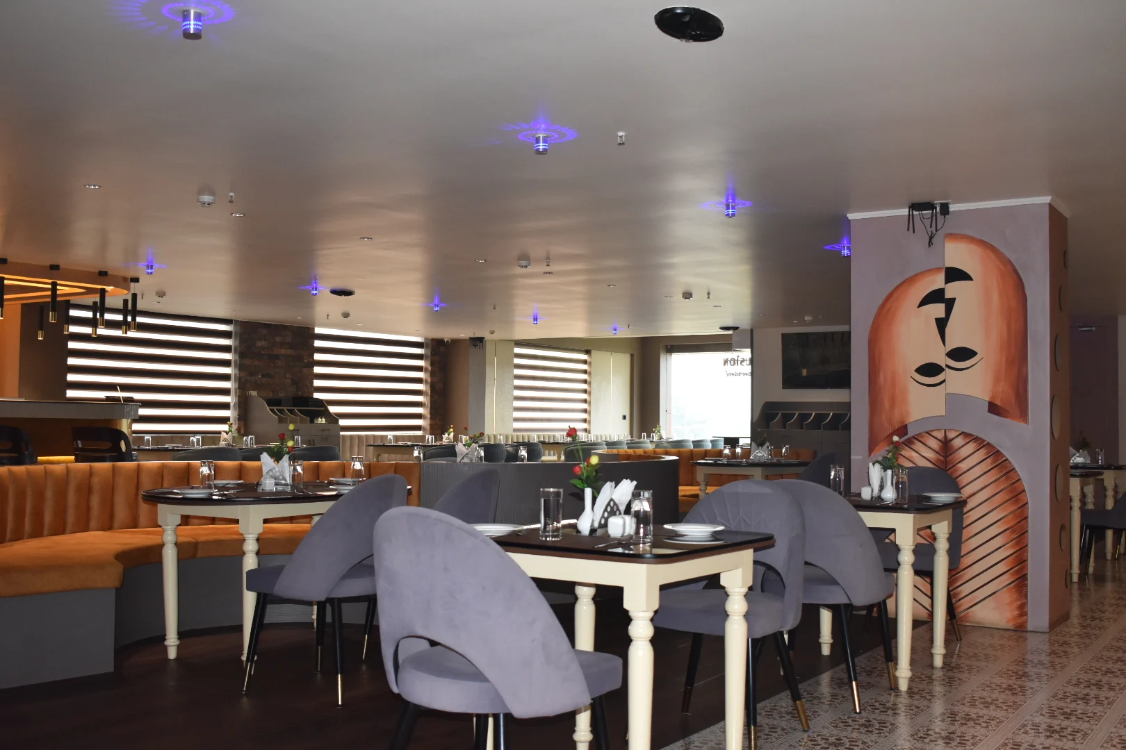 Set tables and seating across the bright Flavor Fusion dining room